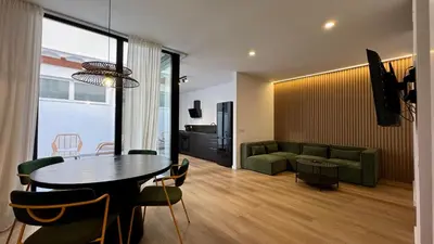 a living room with a table and a couch at Boutique Room - Vila Prades in Valencia