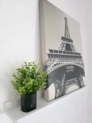 a picture of the eiffel tower on a shelf with a plant at Villa Entre-Azahar, Tu refugio de tranquilidad in Lliria