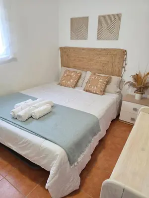 a bedroom with a large bed with towels on it at Villa Entre-Azahar, Tu refugio de tranquilidad in Lliria