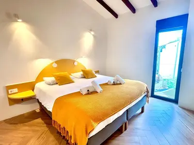 a bedroom with a bed with two towels on it at Casa Tossal in Valencia
