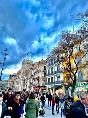 a crowd of people walking down a busy city street at Casa Tossal in Valencia