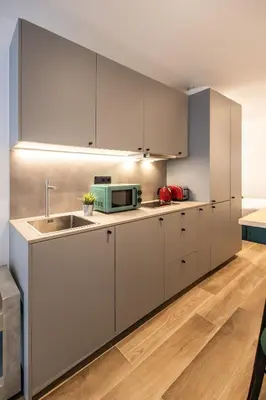 a kitchen with white cabinets and a sink at Cielo y Mar in Valencia