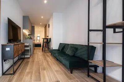 a living room with a green couch and a bunk bed at Cielo y Mar in Valencia