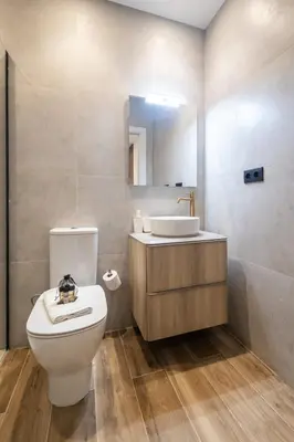 a bathroom with a toilet and a sink and a mirror at Cielo y Mar in Valencia