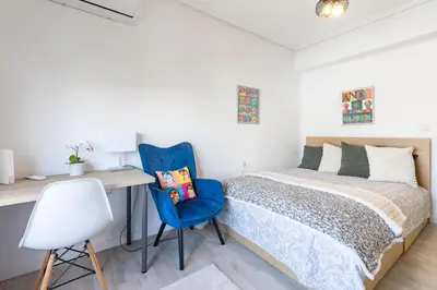a bedroom with a bed and a desk at Valencia Designer Apartment next to metro in Paterna