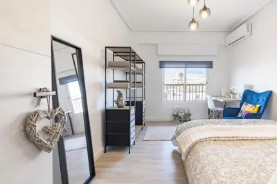 a bedroom with a bed and a mirror at Valencia Designer Apartment next to metro in Paterna