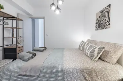 a bedroom with a large bed with pillows on it at Valencia Designer Apartment next to metro in Paterna