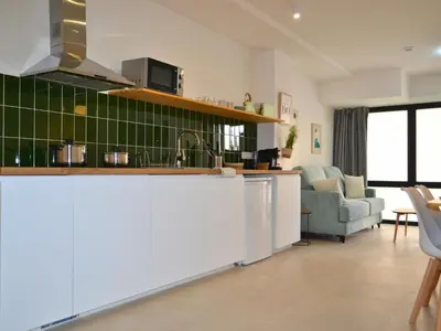 a kitchen and living room with a counter top at Ruzafa & Oceanografic Suites by Illetes Flats in Valencia