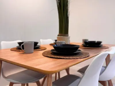 a wooden table with black plates and cups on it at Ruzafa & Oceanografic Suites by Illetes Flats in Valencia