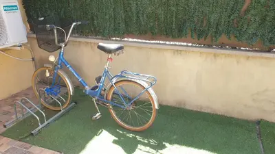 a blue bike parked next to a wall at Adosado acogedor en la Cañada con piscina privada in Partida de La Cañada
