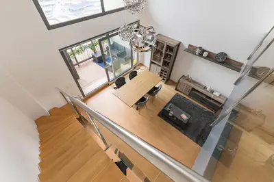 an overhead view of a living room with a table and chairs at Loft Doble Altura con Terraza Panorámica y Piscina in Burjasot