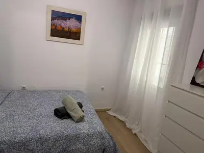 a stuffed animal laying on a bed in a bedroom at Precioso piso acerca de Estación Joaquín Sorolla in Valencia