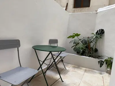 a table and a chair in a room with plants at Precioso piso acerca de Estación Joaquín Sorolla in Valencia