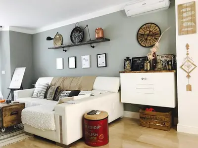 a living room with a white couch and a dartboard on the wall at Cuco in Requena