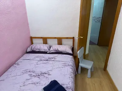 a small bedroom with a bed and a chair at Padre Antonio in Valencia