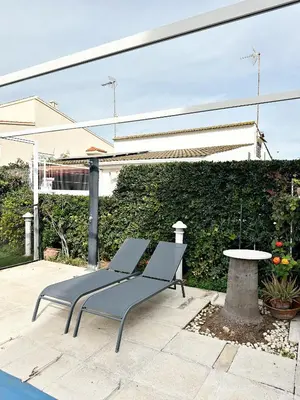 two chairs and a table on a patio at Villa en la Playa I 5BR I 5 WC I Piscina Privada in Sueca