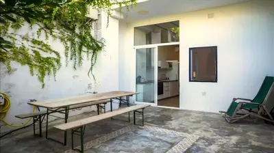 a room with a table and chairs and a tv at House near beach w-terrace in Valencia