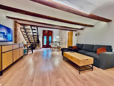 a living room with a couch and a table at Duplex en el Carmen in Valencia