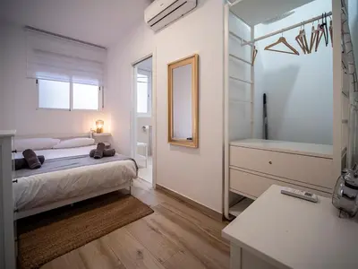 a bedroom with a bed and a mirror and a sink at Apartment Ruzafa Market 6B in Valencia