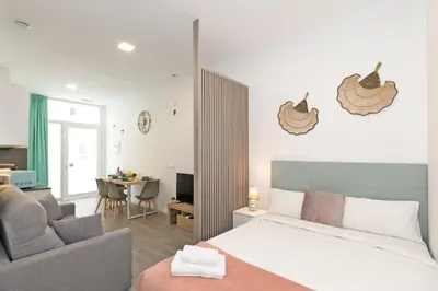 a bedroom with a bed and a living room at GuestReady - Fontilles apartments in Valencia