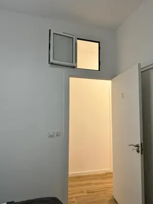 a room with a microwave on top of a wall at Habitacion privada con baño privado II in Valencia
