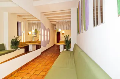 a corridor of a hospital with a green couch at GuestReady - Stay near the Central Market in Valencia