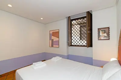 two beds in a room with a window at GuestReady - Stay near the Central Market in Valencia