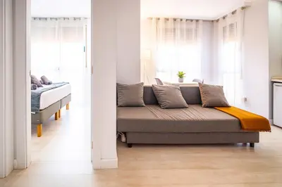 a living room with a couch and two windows at Apartment Ruzafa Market 7B in Valencia