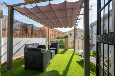 a patio with grass and chairs on a balcony at ChillOut Area 2BR 4P City Relax Fast WiFi Pet Friendly in Valencia