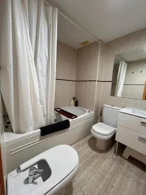 a bathroom with a tub and a toilet and a sink at Casa familiar 3 dormitorios Jardín Piscina Barbacoa Zona de entrenamiento in Bétera