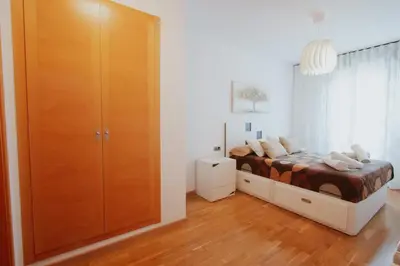 a bedroom with a bed and a large wooden cabinet at Family & Friends Apartment with Pool in Torrent