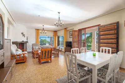 a dining room with a white table and chairs at Masia Miliuca Paraíso rural a un paso de Valencia - Rural paradise close to Valencia in Bétera