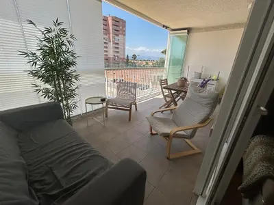 a living room with a couch and chairs on a balcony at Canet al Mar Luxe y Confort-Pet Friendly in Canet de Berenguer