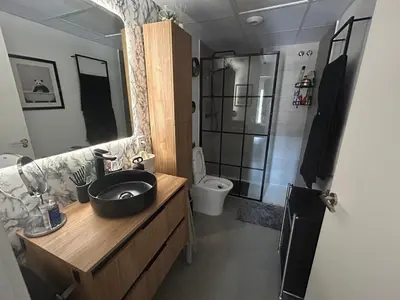 a bathroom with a sink and a shower with a toilet at Canet al Mar Luxe y Confort-Pet Friendly in Canet de Berenguer