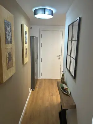 a room with a hallway with a table and a door at Canet al Mar Luxe y Confort-Pet Friendly in Canet de Berenguer