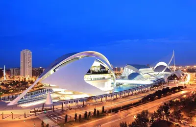 a view of a building with an arch at night at Great apartment in Sciences City in Valencia