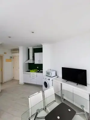 a living room with a tv and a table and chairs at Apartment Ruzafa Market 7C in Valencia