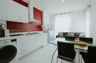 a kitchen with white cabinets and a pizza on a table at Apartment Ruzafa Market 7D in Valencia