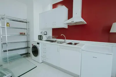 a white kitchen with a sink and a washing machine at Apartment Ruzafa Market 7D in Valencia