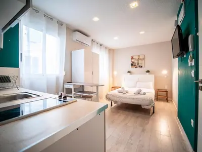 a kitchen and living room with a bed in a room at Apartment Ruzafa Market 8A in Valencia