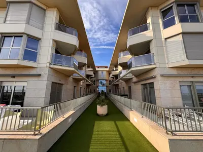 an internal walkway between two apartment buildings at Valencia Beach Vibe - Oceanfront escape in Valencia