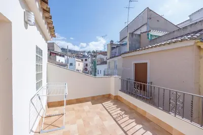 a balcony of a white building with a metal railing at Gatova Sunset Retreat in Gátova