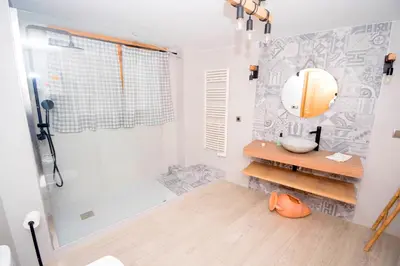 a bathroom with a shower and a sink and a mirror at En el corazón de Sagunto in Sagunto