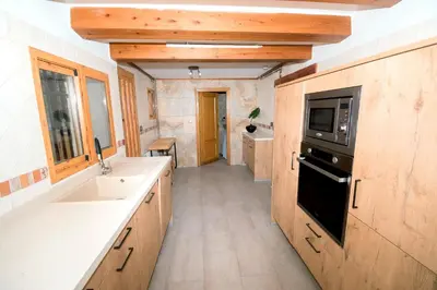 a large kitchen with a sink and a microwave at En el corazón de Sagunto in Sagunto