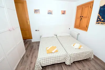 a bedroom with a bed with two towels on it at En el corazón de Sagunto in Sagunto