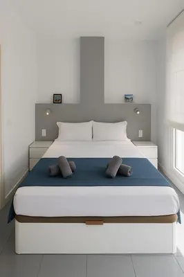 a bedroom with a large white bed with two pillows at Your Apartment In The Center-Ruzafa 8C in Valencia