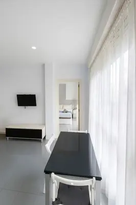 a white room with a black table and a bed at Your Apartment In The Center-Ruzafa 8C in Valencia
