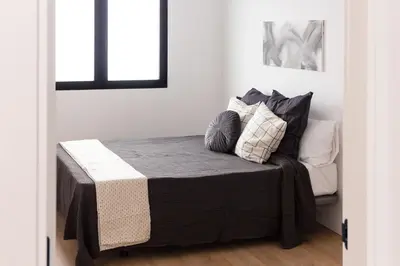 a bed with pillows on it in a room at Valencia Leones by Concept Flats in Valencia