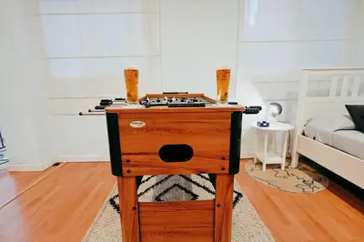 a wooden table in a room with a bed at Fun Apt, City of Arts, ChillOut Zone, Soccer Table in Valencia