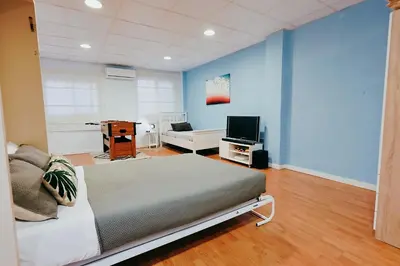 a bedroom with a bed and a tv in it at Fun Apt, City of Arts, ChillOut Zone, Soccer Table in Valencia